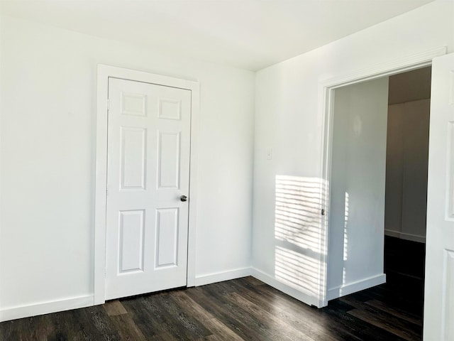 spare room with dark hardwood / wood-style flooring