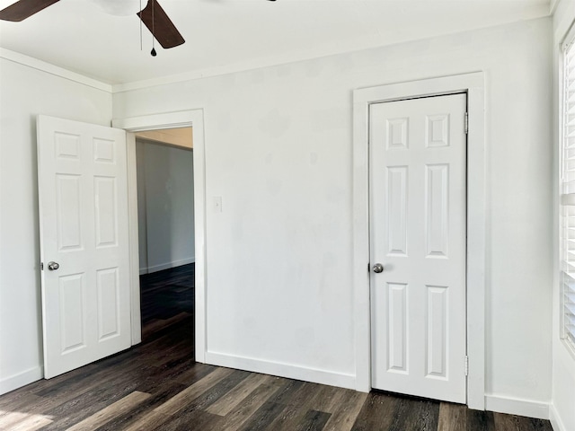 unfurnished bedroom featuring a closet, ceiling fan, and dark hardwood / wood-style flooring