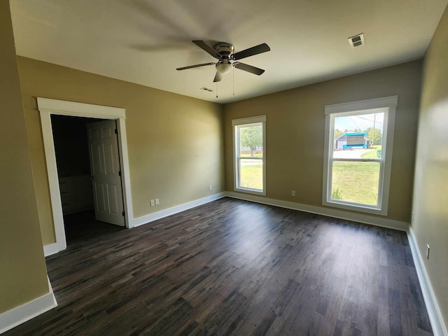 unfurnished room featuring dark hardwood / wood-style flooring and ceiling fan