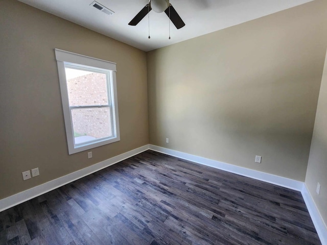 empty room with ceiling fan and dark hardwood / wood-style flooring