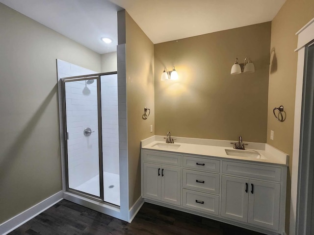 bathroom featuring vanity, an enclosed shower, and hardwood / wood-style flooring