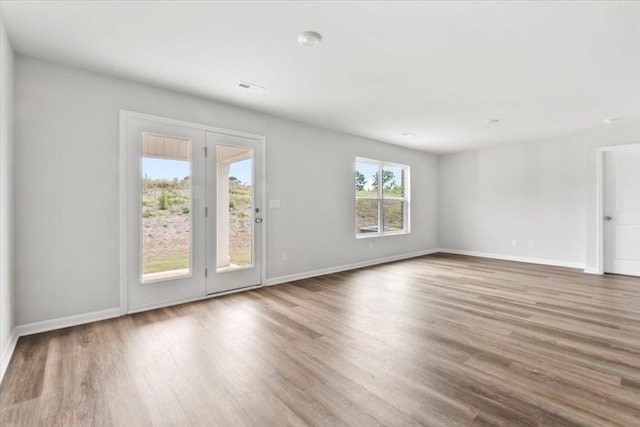  - unfurnished living room featuring wood finished floors and baseboards