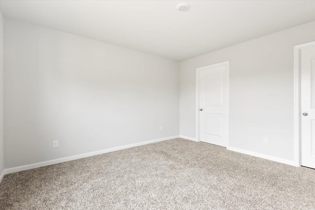  - spare room featuring carpet floors and baseboards