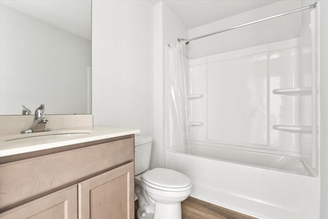  - full bathroom with toilet, vanity, wood finished floors, and shower / bath combination with curtain