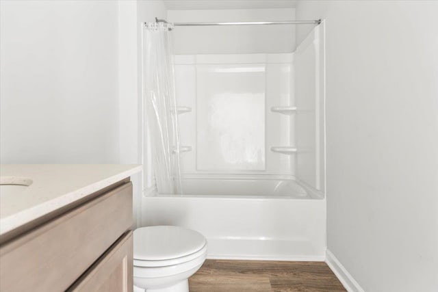  - bathroom featuring vanity, wood finished floors, shower / tub combo with curtain, and toilet