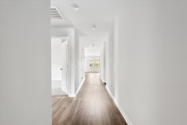  - hallway featuring wood finished floors and baseboards