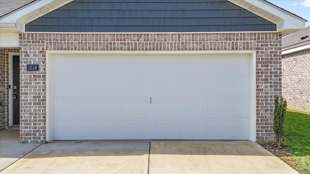 - garage featuring concrete driveway