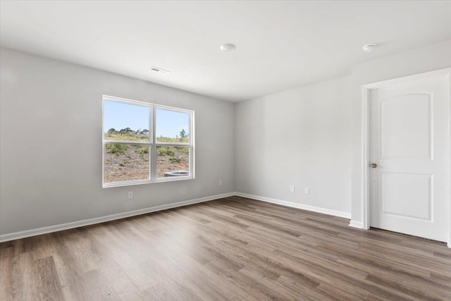 - unfurnished room featuring wood finished floors and baseboards
