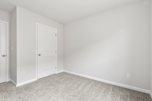  - unfurnished bedroom with light colored carpet and baseboards