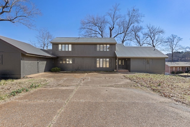 view of front of house with metal roof and concrete driveway