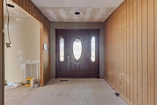 entryway featuring wooden walls