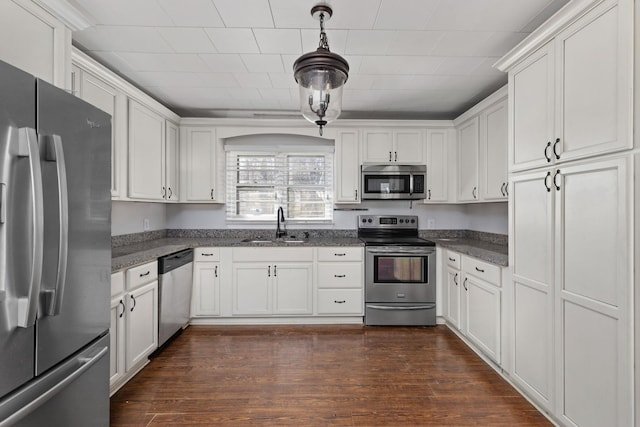 kitchen featuring a sink, white cabinets, dark wood finished floors, and stainless steel appliances