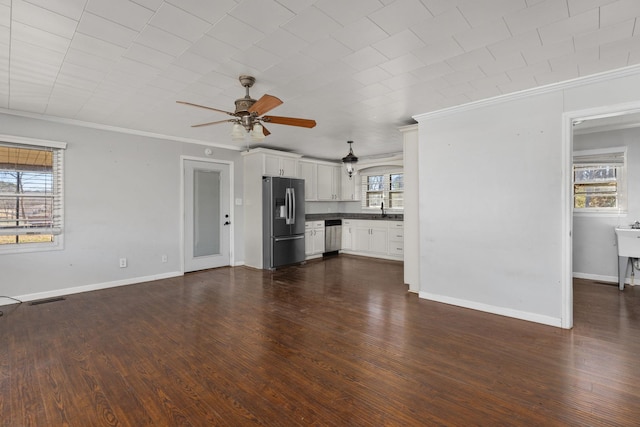 unfurnished living room featuring crown molding, a ceiling fan, dark wood-style flooring, and a sink