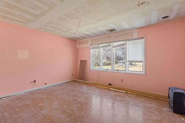 spare room with visible vents and baseboards