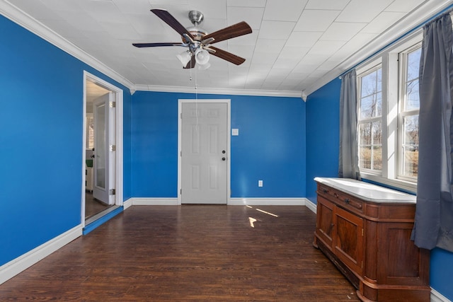 entryway with baseboards, wood finished floors, a ceiling fan, and crown molding