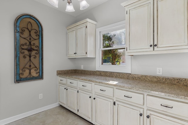 kitchen featuring light stone counters and light tile patterned floors