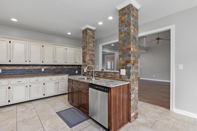 kitchen with ceiling fan, dishwasher, sink, decorative columns, and light tile patterned floors