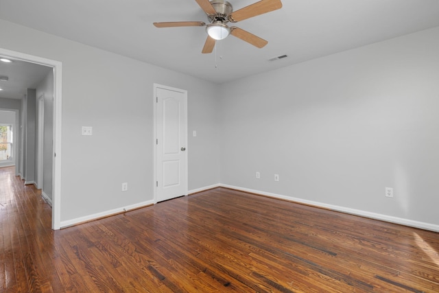 unfurnished room with ceiling fan and dark hardwood / wood-style flooring