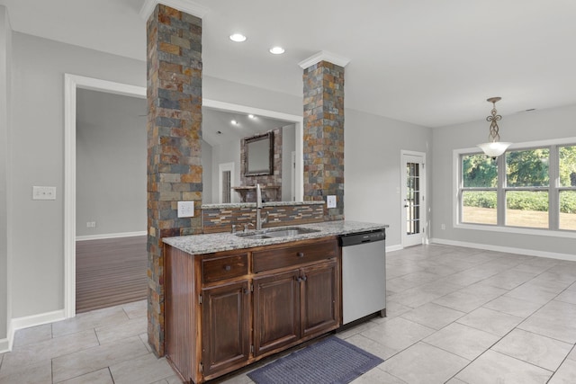 kitchen featuring light stone countertops, sink, hanging light fixtures, stainless steel dishwasher, and decorative columns