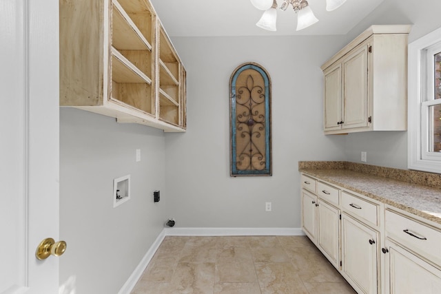 laundry area with ceiling fan, hookup for a washing machine, light tile patterned flooring, and cabinets