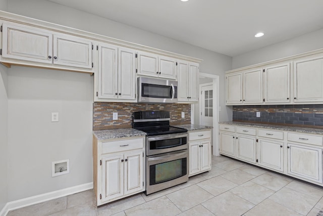 kitchen with decorative backsplash, light stone countertops, and stainless steel appliances