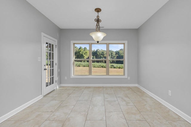 unfurnished dining area featuring light tile patterned floors