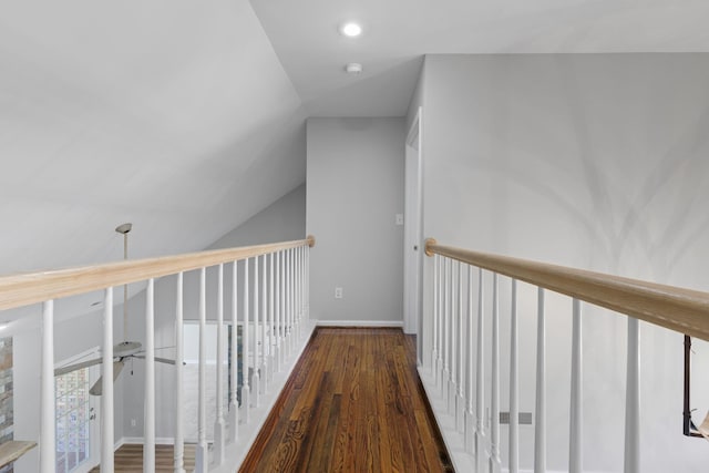 corridor featuring dark hardwood / wood-style floors and vaulted ceiling