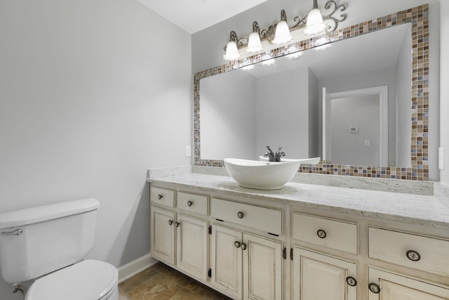 bathroom with tile patterned flooring, vanity, and toilet