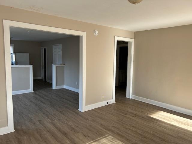 empty room with dark hardwood / wood-style floors