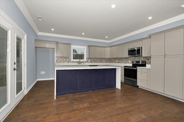 kitchen featuring a kitchen island, crown molding, appliances with stainless steel finishes, and tasteful backsplash