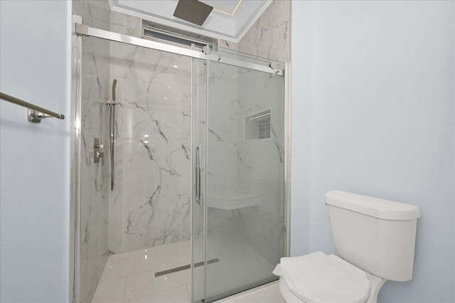 bathroom with toilet and a shower with door