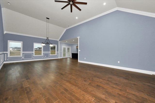 unfurnished living room featuring ceiling fan, dark hardwood / wood-style flooring, crown molding, and vaulted ceiling