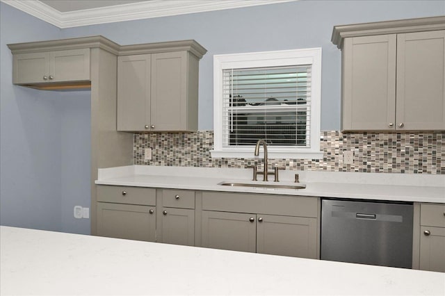 kitchen featuring gray cabinetry, sink, tasteful backsplash, stainless steel dishwasher, and crown molding