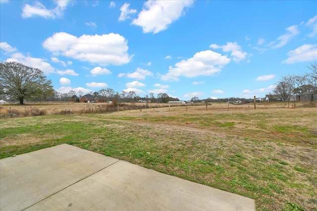 view of yard featuring a rural view and a patio area