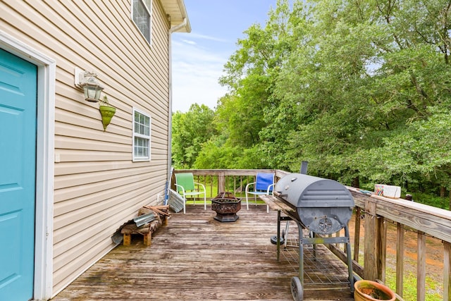  - wooden deck with a fire pit and area for grilling