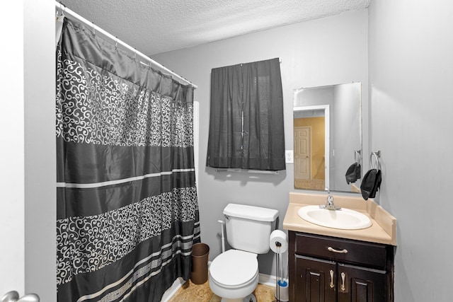  - bathroom with a textured ceiling, vanity, and toilet