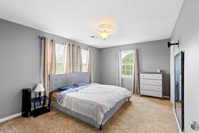  - bedroom with carpet flooring, a textured ceiling, and baseboards