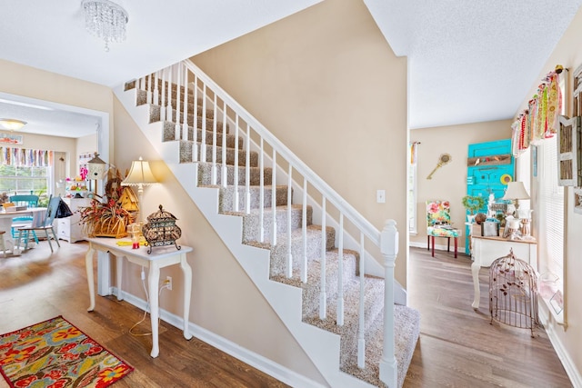  - stairway featuring wood finished floors and baseboards