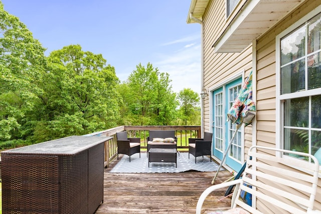  - wooden terrace featuring an outdoor living space