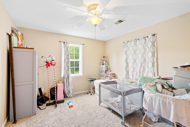  - interior space featuring carpet, a ceiling fan, baseboards, and a textured ceiling