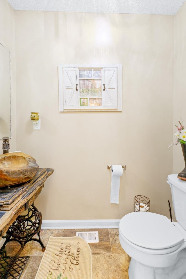  - bathroom with toilet and baseboards