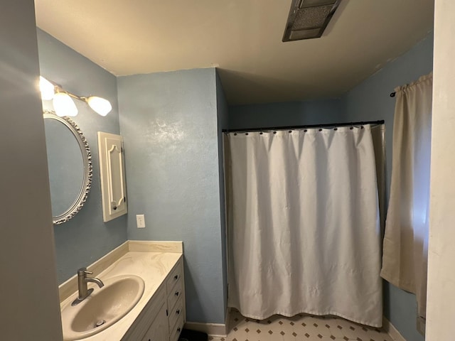 - full bathroom with vanity, baseboards, and a shower with curtain
