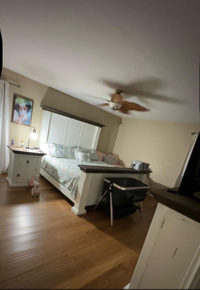  - bedroom with dark wood-style flooring and a ceiling fan