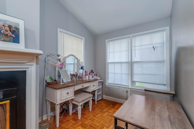  - office area featuring vaulted ceiling, plenty of natural light, and baseboards