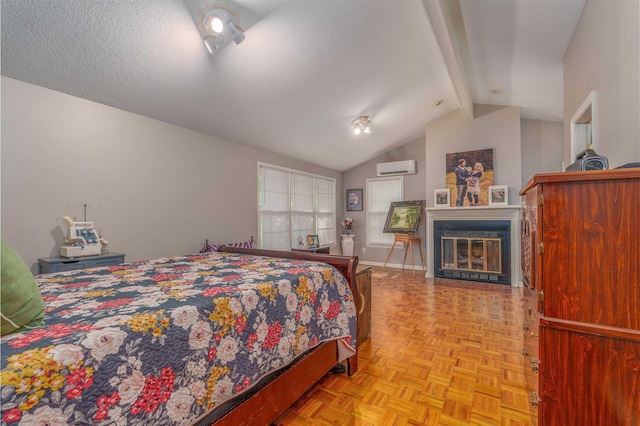  - bedroom featuring a wall mounted air conditioner, a glass covered fireplace, and baseboards