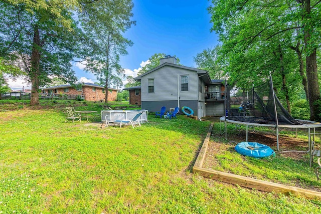  - view of green lawn featuring a trampoline