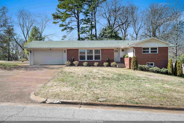 single story home featuring a garage, concrete driveway, brick siding, and a front lawn