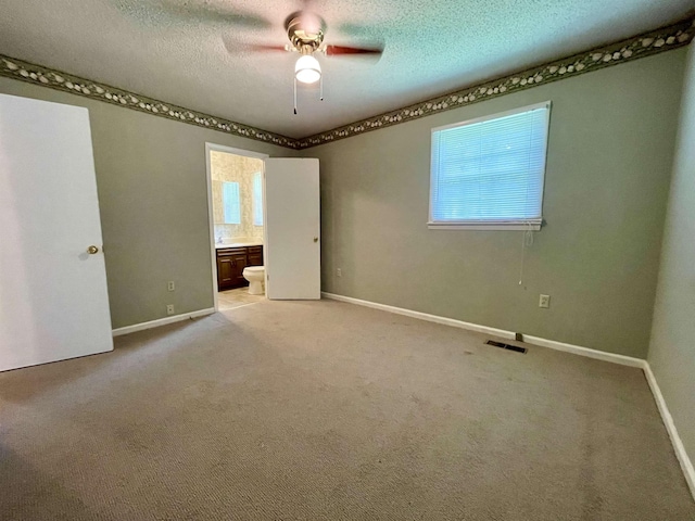  - empty room with healthy amount of natural light, ceiling fan, light carpet, and a textured ceiling