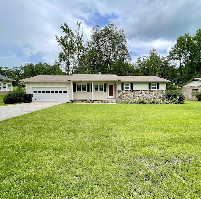 - single story home featuring a garage, driveway, a front yard, and stone siding