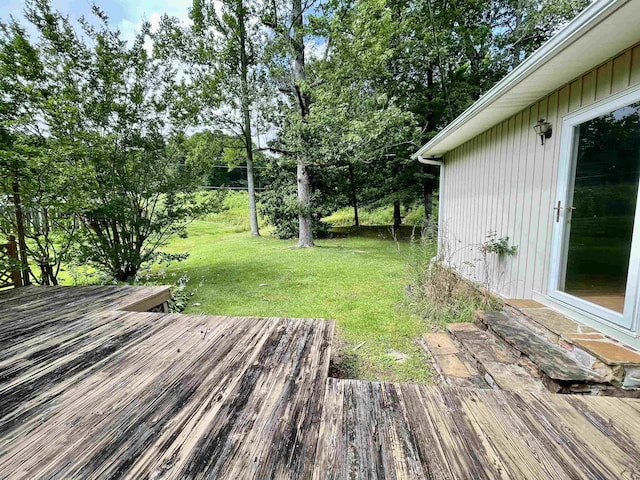  - deck with a yard and view of wooded area